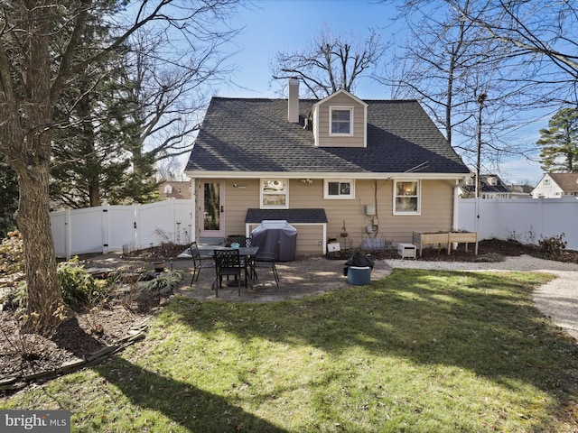 back of property featuring a yard and a patio area