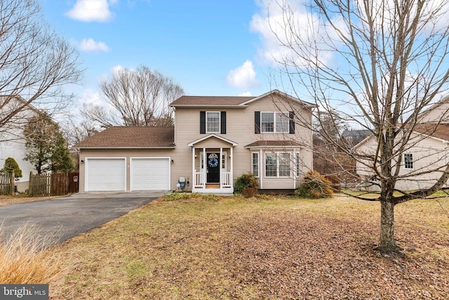 view of front property featuring a garage and a front lawn