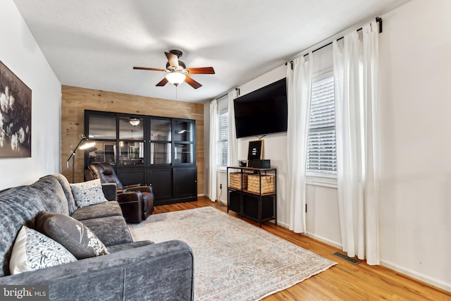 living room featuring ceiling fan and hardwood / wood-style floors