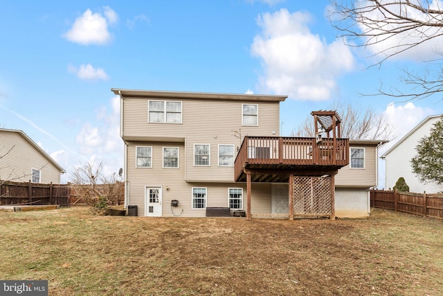 rear view of property with a wooden deck and a yard