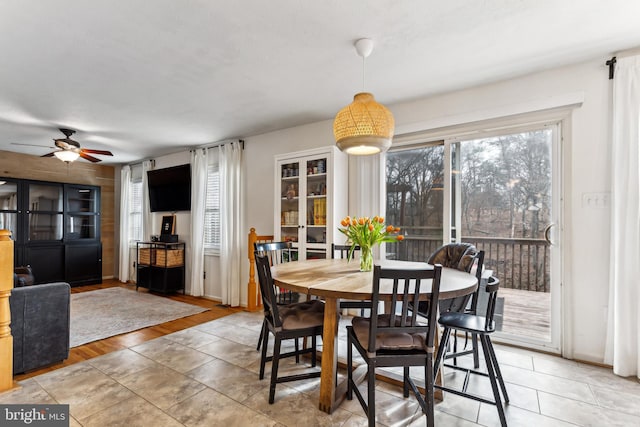 tiled dining space featuring ceiling fan