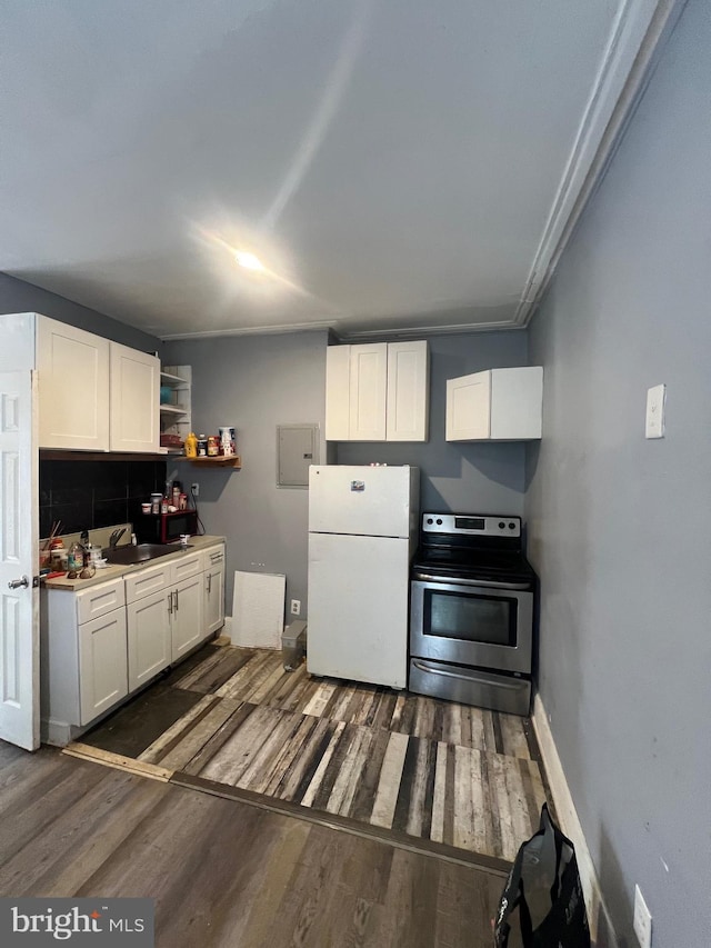 kitchen with sink, dark wood-type flooring, white cabinetry, white refrigerator, and stainless steel electric range oven