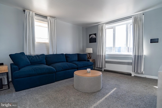 living room featuring plenty of natural light, carpet flooring, and radiator heating unit