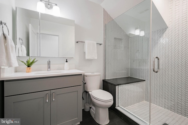 bathroom featuring an enclosed shower, vanity, tile patterned floors, and toilet