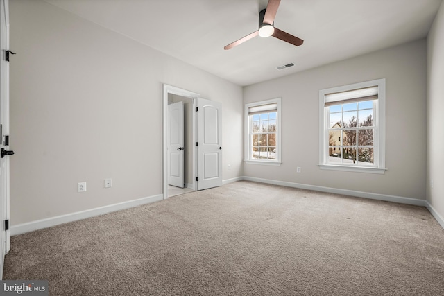 unfurnished bedroom with light carpet and ceiling fan