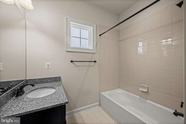 bathroom featuring tile patterned floors, tiled shower / bath combo, and vanity