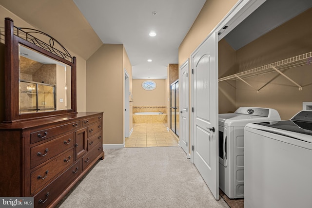 clothes washing area featuring washer and dryer and light carpet