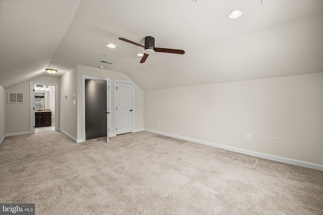 bonus room featuring vaulted ceiling, light carpet, and ceiling fan