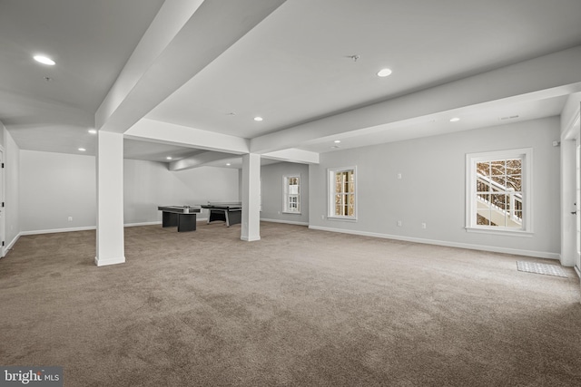 basement featuring plenty of natural light and carpet