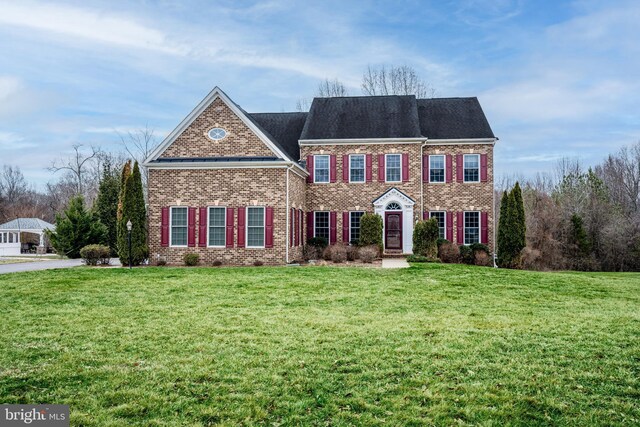 colonial-style house with a front lawn