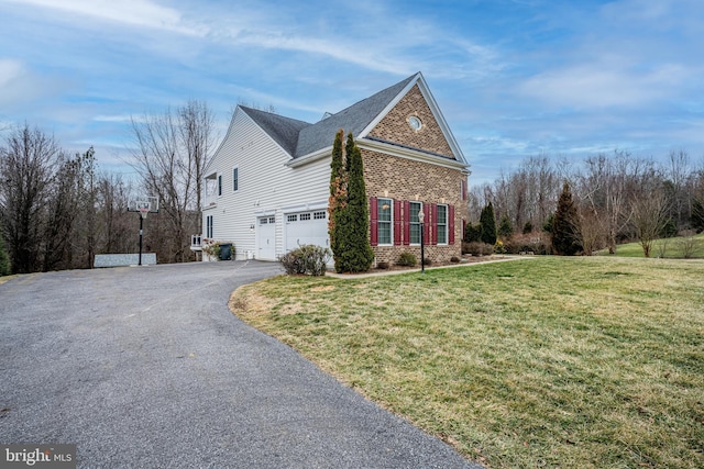 view of home's exterior with a garage and a lawn