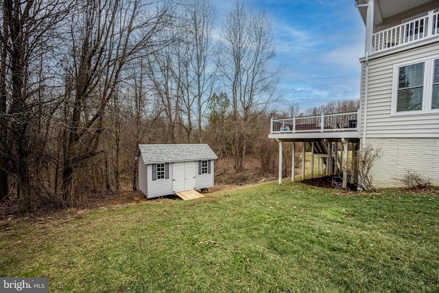 view of yard featuring a wooden deck and a storage unit