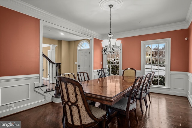 dining area featuring a notable chandelier, ornamental molding, dark hardwood / wood-style floors, and ornate columns