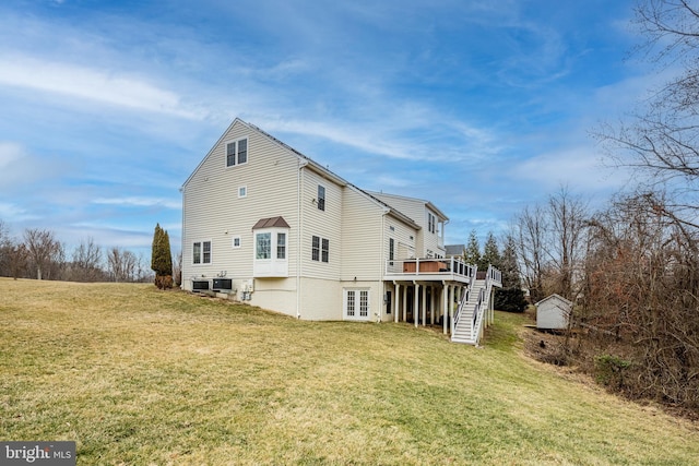 rear view of house featuring a yard and a deck