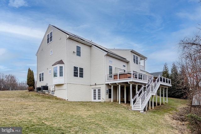 back of house featuring a wooden deck and a yard