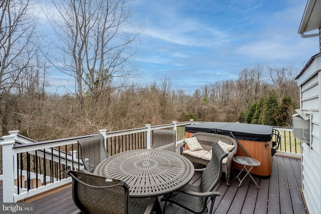 wooden deck featuring a hot tub