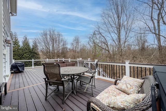 wooden deck with a grill