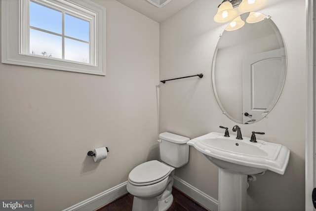 bathroom with toilet and hardwood / wood-style floors