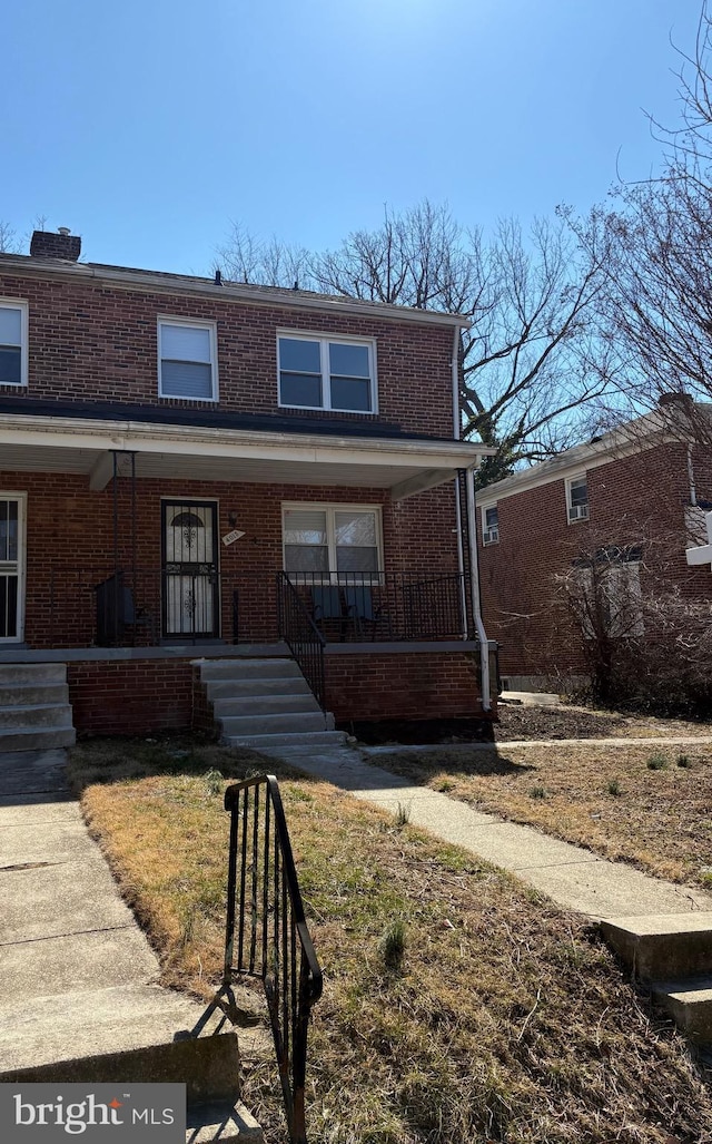 view of front of property with a porch and brick siding