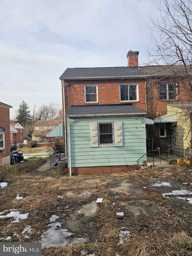 rear view of property with a chimney