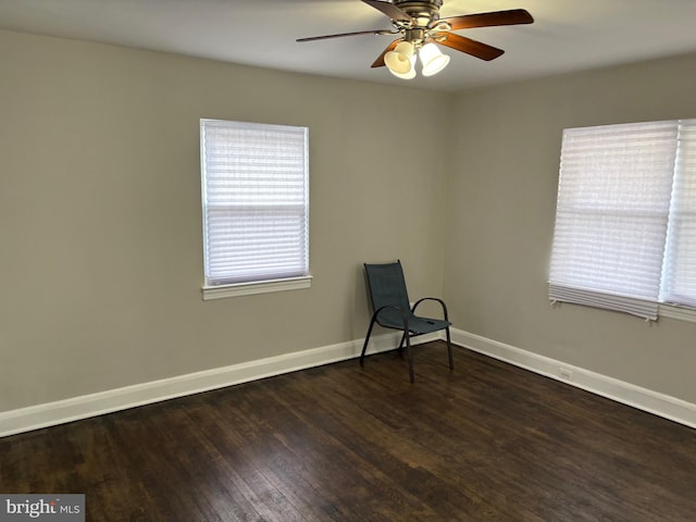 unfurnished room featuring ceiling fan, baseboards, and wood finished floors