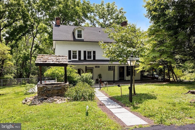 back of property featuring a patio area and a lawn