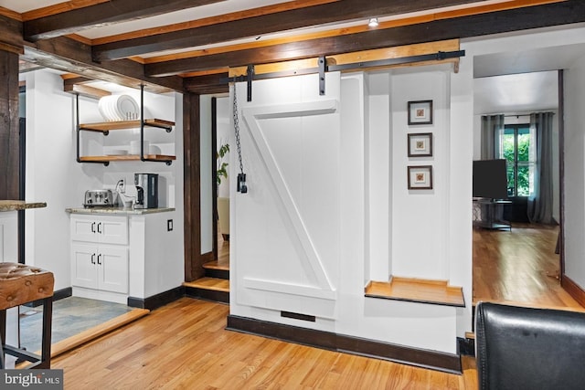 interior space featuring a barn door and light wood-type flooring