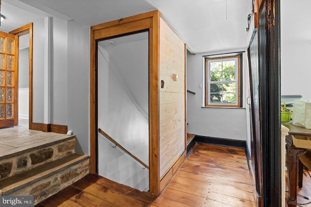 hall with wood-type flooring