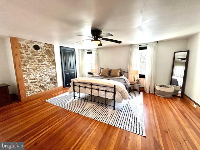 bedroom with hardwood / wood-style flooring and ceiling fan