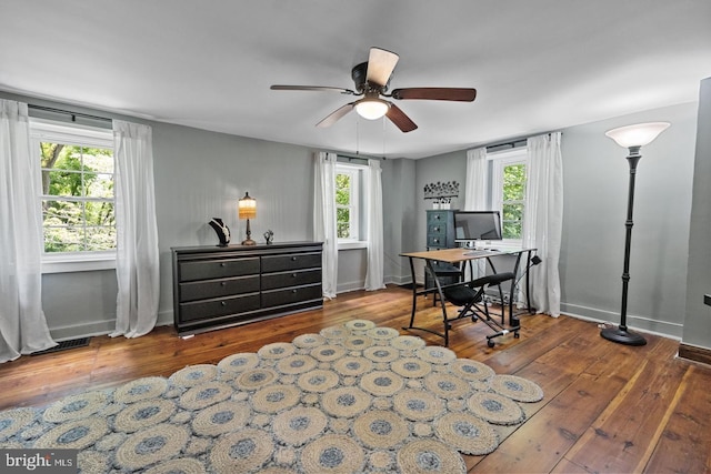 office area with plenty of natural light, hardwood / wood-style floors, and ceiling fan