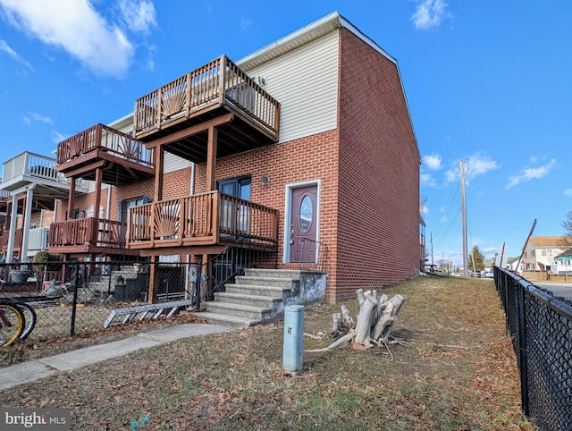 rear view of property with a wooden deck