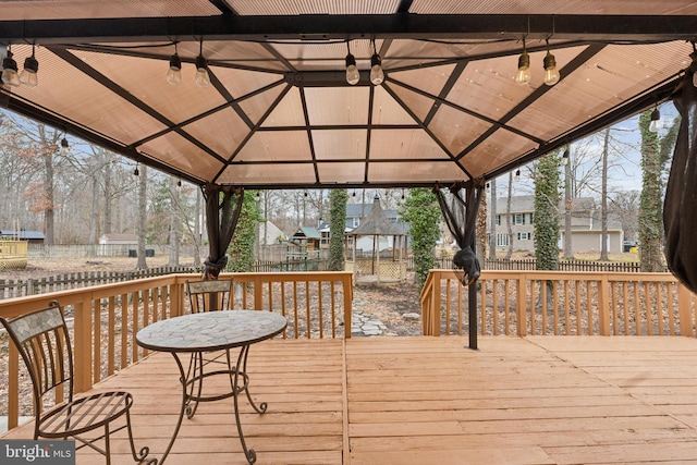 wooden deck featuring a residential view and a gazebo