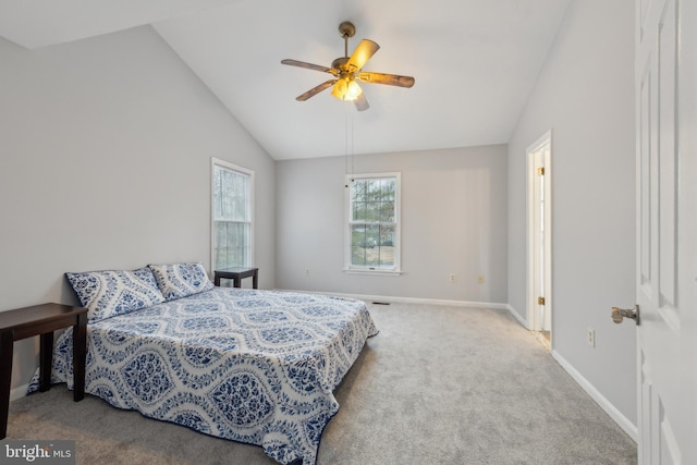 carpeted bedroom with ceiling fan, baseboards, and vaulted ceiling