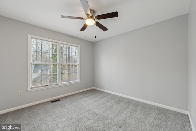 unfurnished room featuring baseboards, visible vents, and carpet flooring