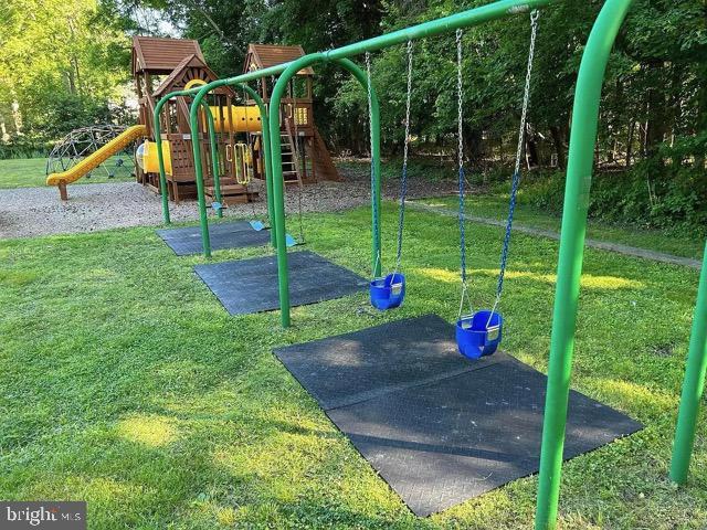 communal playground featuring a lawn