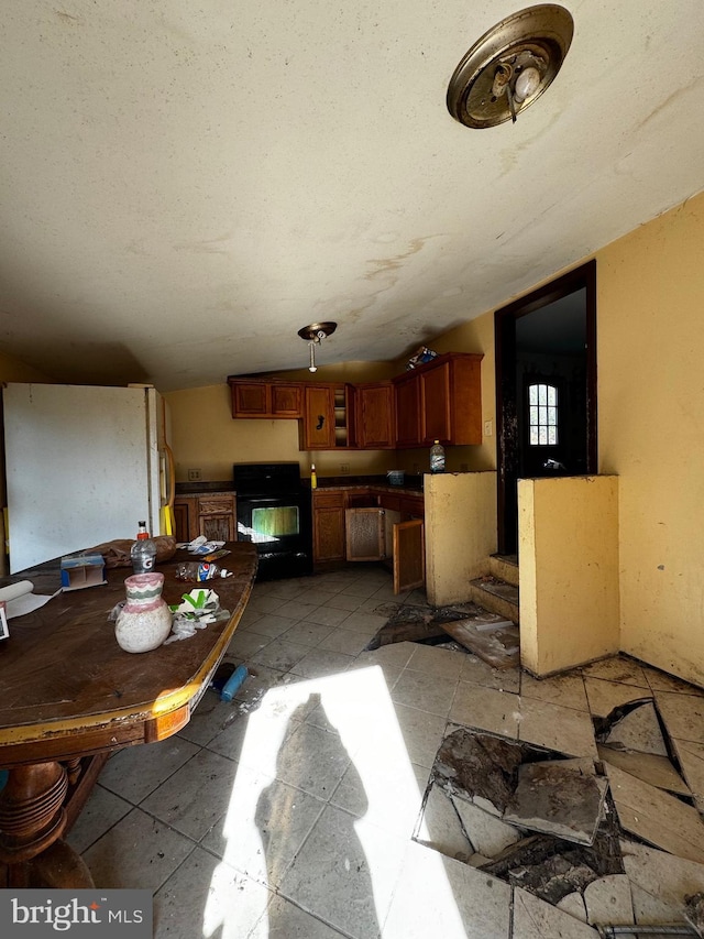 dining room with lofted ceiling and a textured ceiling