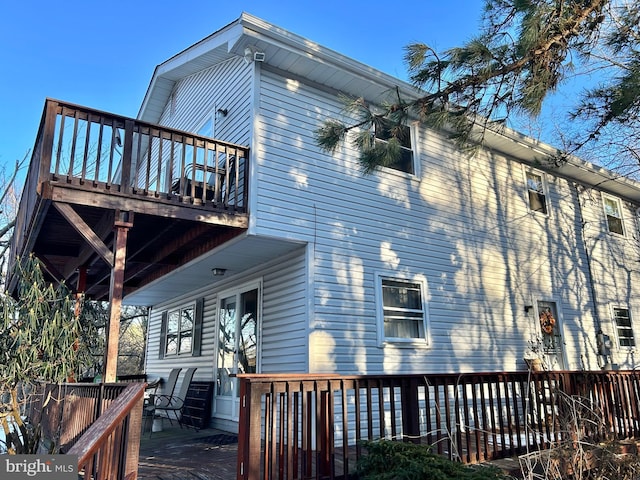 rear view of property with a wooden deck