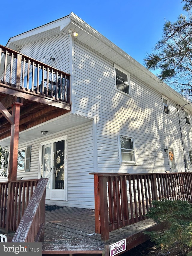 back of house featuring a wooden deck