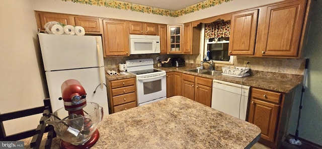 kitchen with white appliances, sink, and decorative backsplash