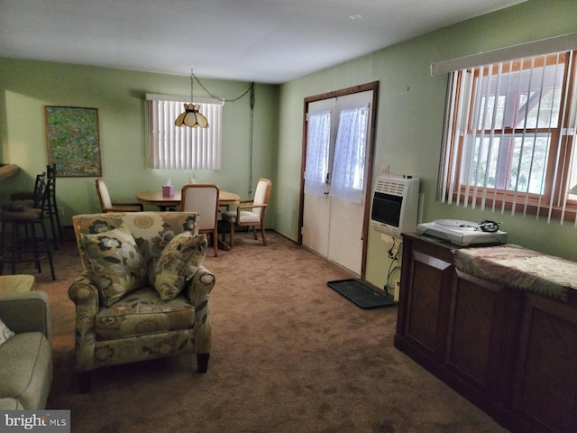 living room with carpet, plenty of natural light, and heating unit