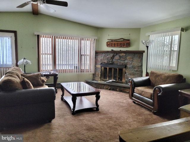 carpeted living room featuring a healthy amount of sunlight, a fireplace, and lofted ceiling with beams