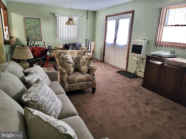 carpeted living room with plenty of natural light, a baseboard heating unit, and heating unit