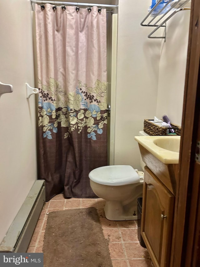 bathroom with vanity, toilet, and a baseboard heating unit