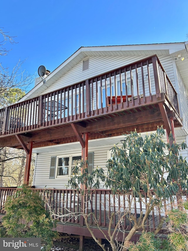 rear view of property with a wooden deck