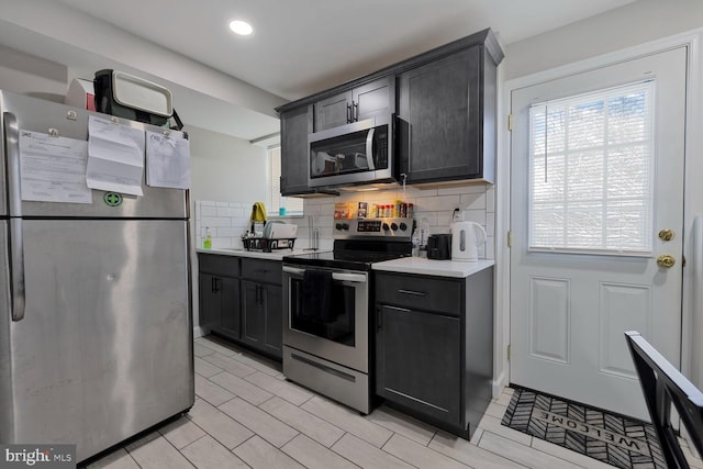 kitchen featuring stainless steel appliances and backsplash