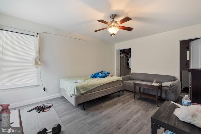 bedroom featuring wood-type flooring, a closet, and ceiling fan