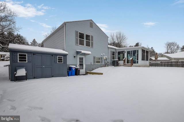 snow covered back of property with central air condition unit