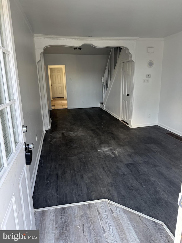 unfurnished room with dark wood-type flooring