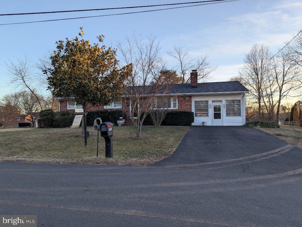 ranch-style home featuring a yard