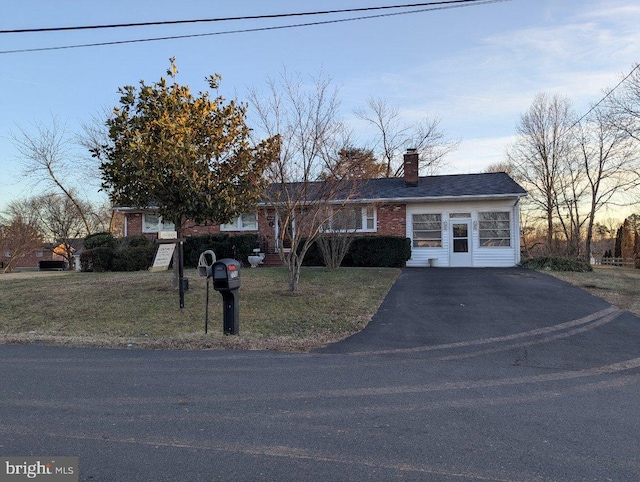 ranch-style home with a yard